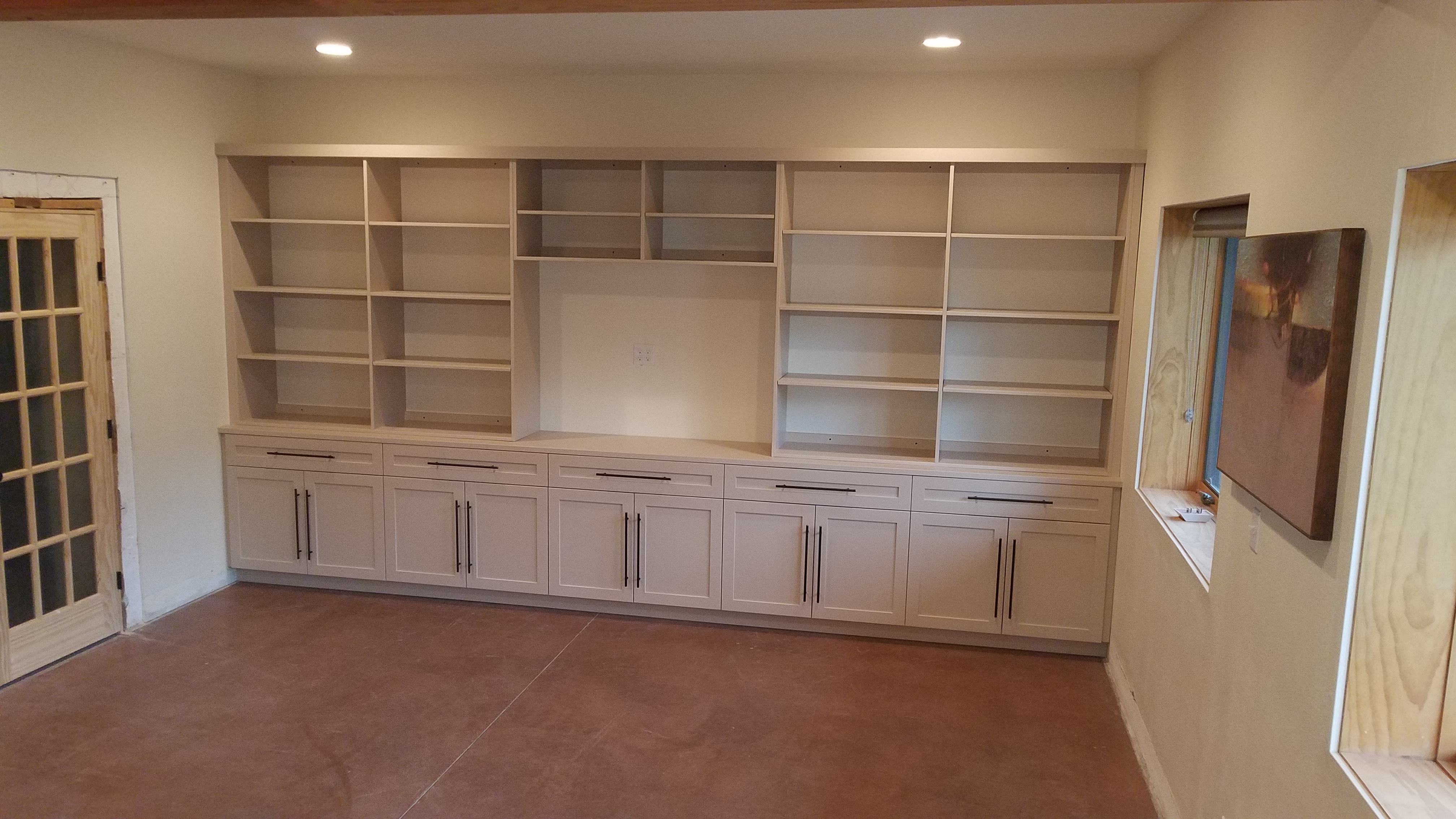 large custom builtin bookshelves and entertainment center with cabinets