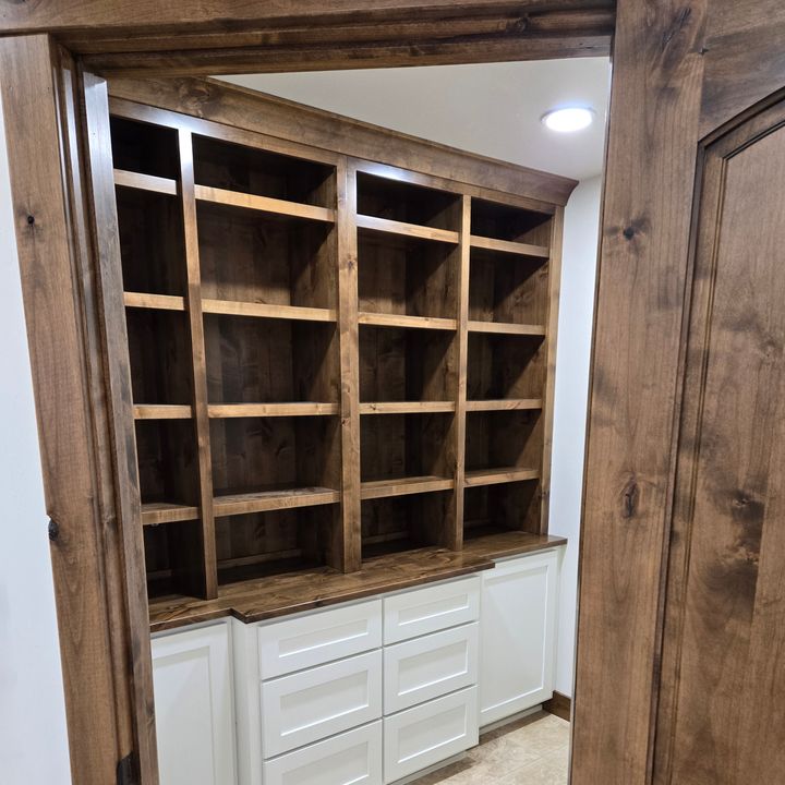 custom dark pantry shelves with white millwork and trim detail