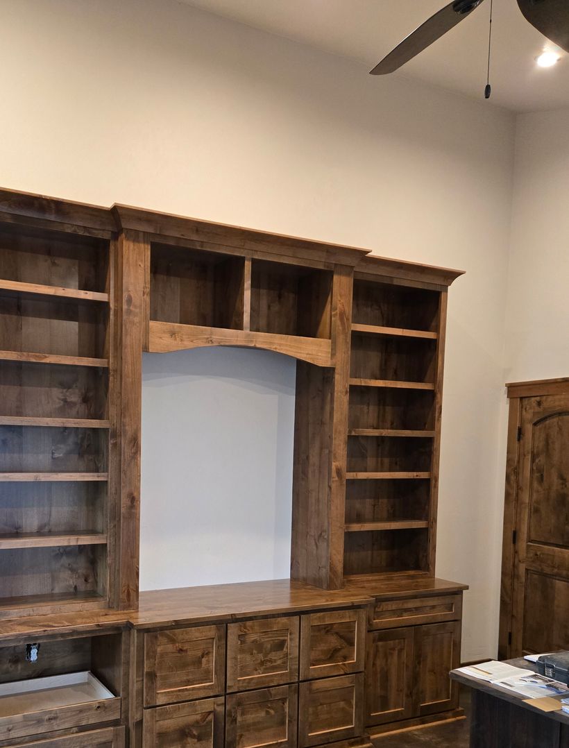 custom dark finished entertainment center with shelves and drawers