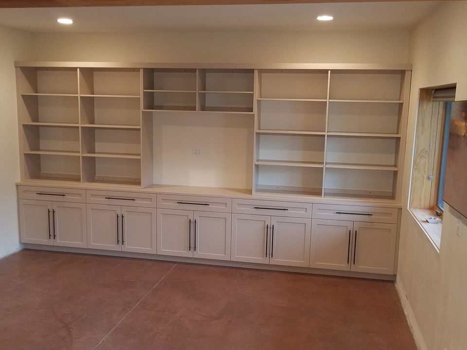 custom built-in entertainment center with white finish and matching cabinetry