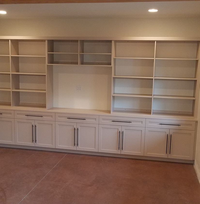 custom built and finished built in white bookshelf with cabinets