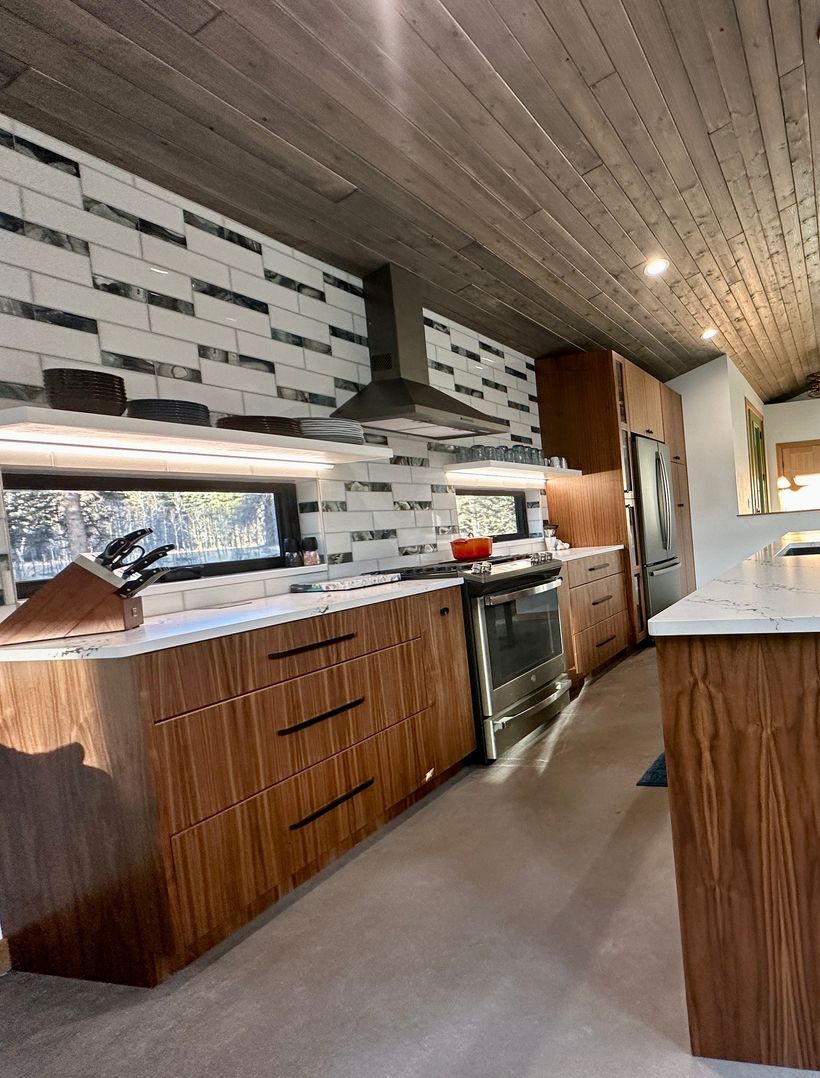 modern custom kitchen cabinets with black and white backsplash in large kitchen