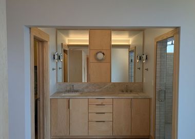 custom bathroom vanity with dual sinks, LED mirror, and marble countertop