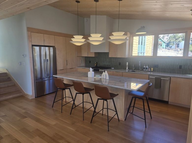 natural maple kitchen cabinets with large island in open plan home
